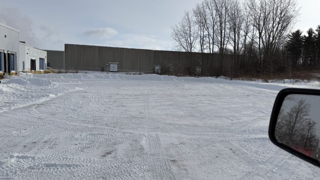 Commercial snow removal crew clearing a parking lot in London, Ontario