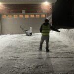 Professional snow removal service clearing a residential driveway in London, Ontario"