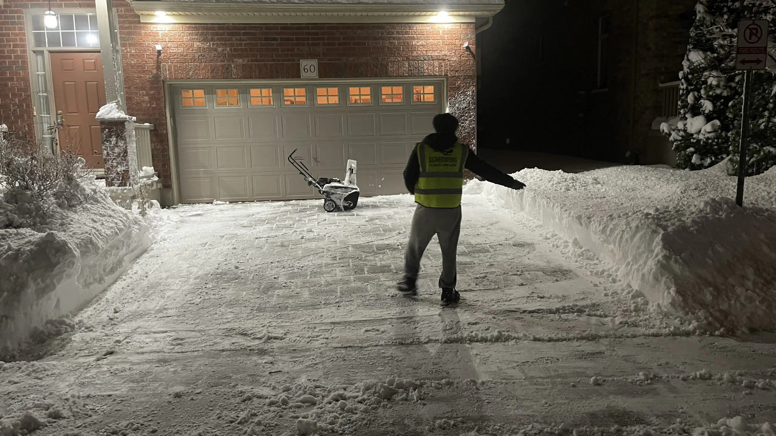 Professional snow removal service clearing a residential driveway in London, Ontario"