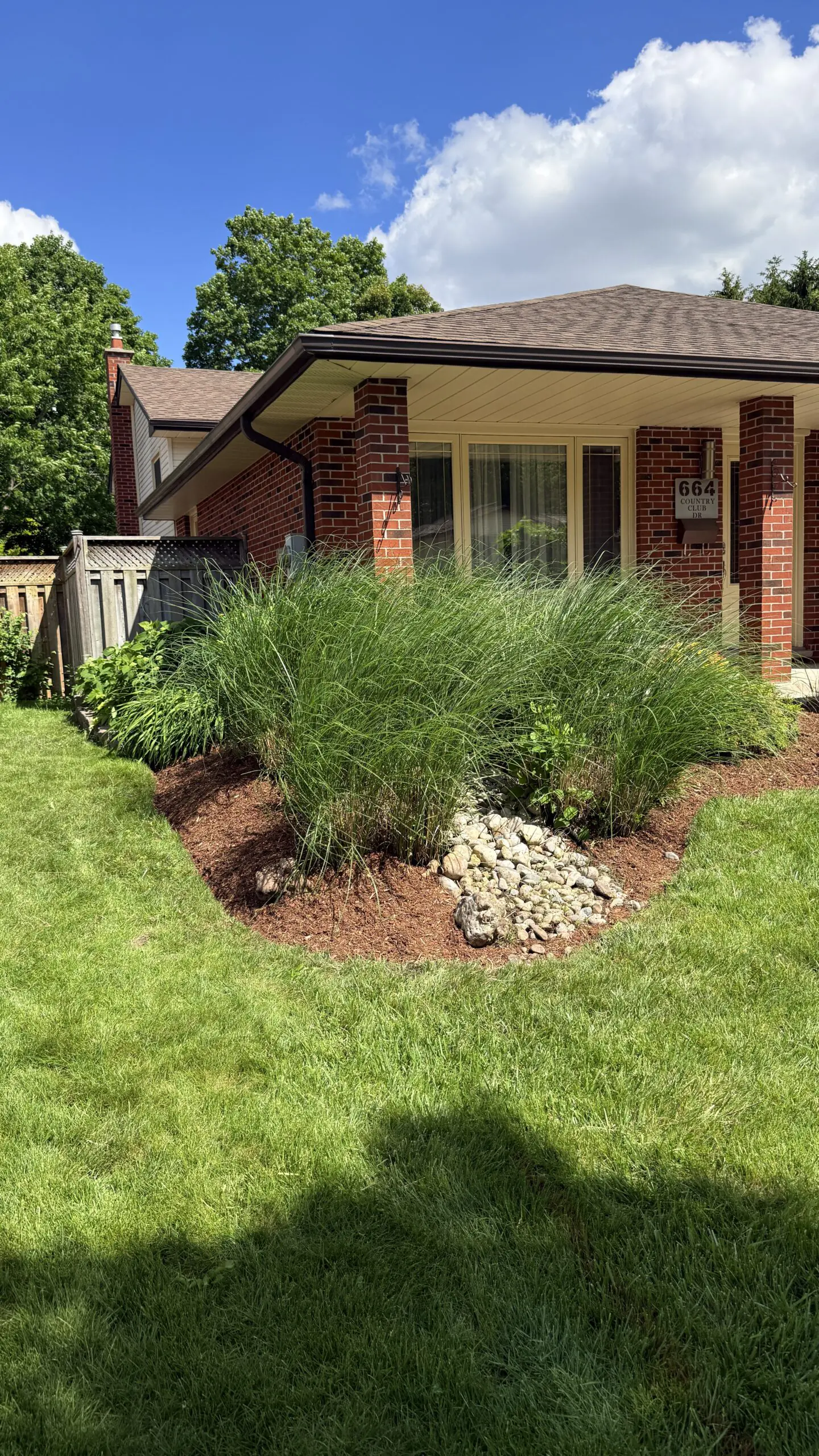 Before and after garden bed cleanup with crispy defined edges in London Ontario
